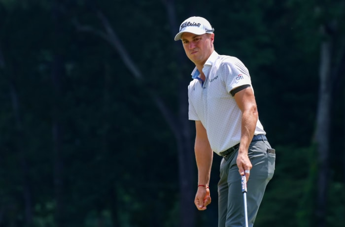 Justin Thomas reacts to a putt on the 9th green during the third round of the Wyndham Championship golf tournament.